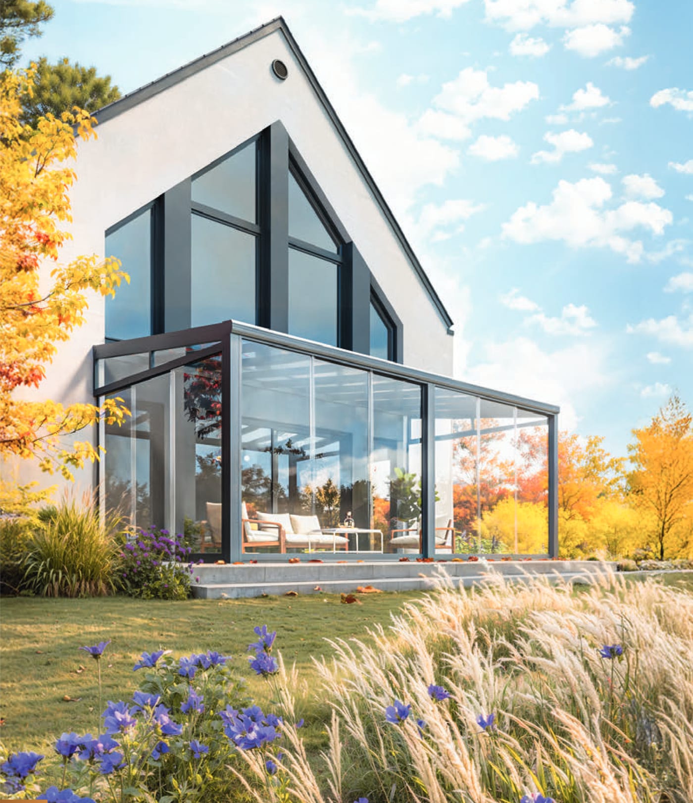 Kaltwintergarten aus Aluminium und Glas an einem Wohnhaus im Herbst
