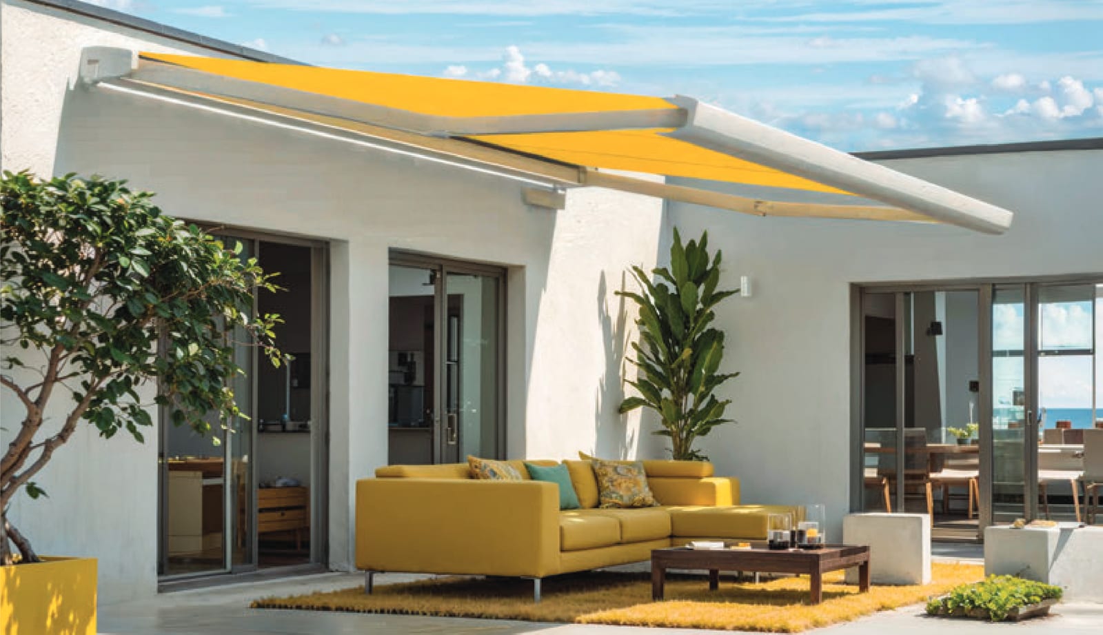 Gelbe Kassettenmarkise über einer Lounge-Terrasse